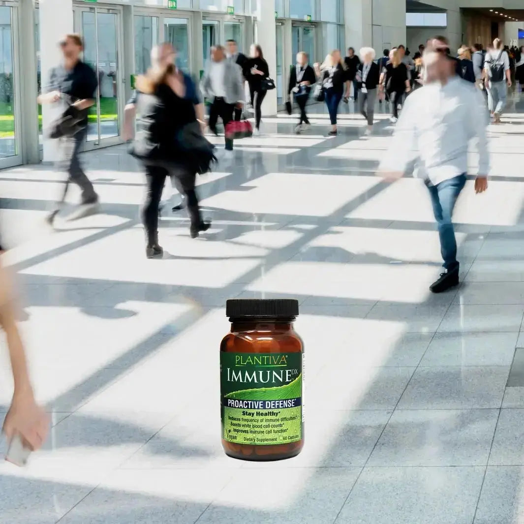 Bottle of ImmuneDx with people walking in a busy mall.
