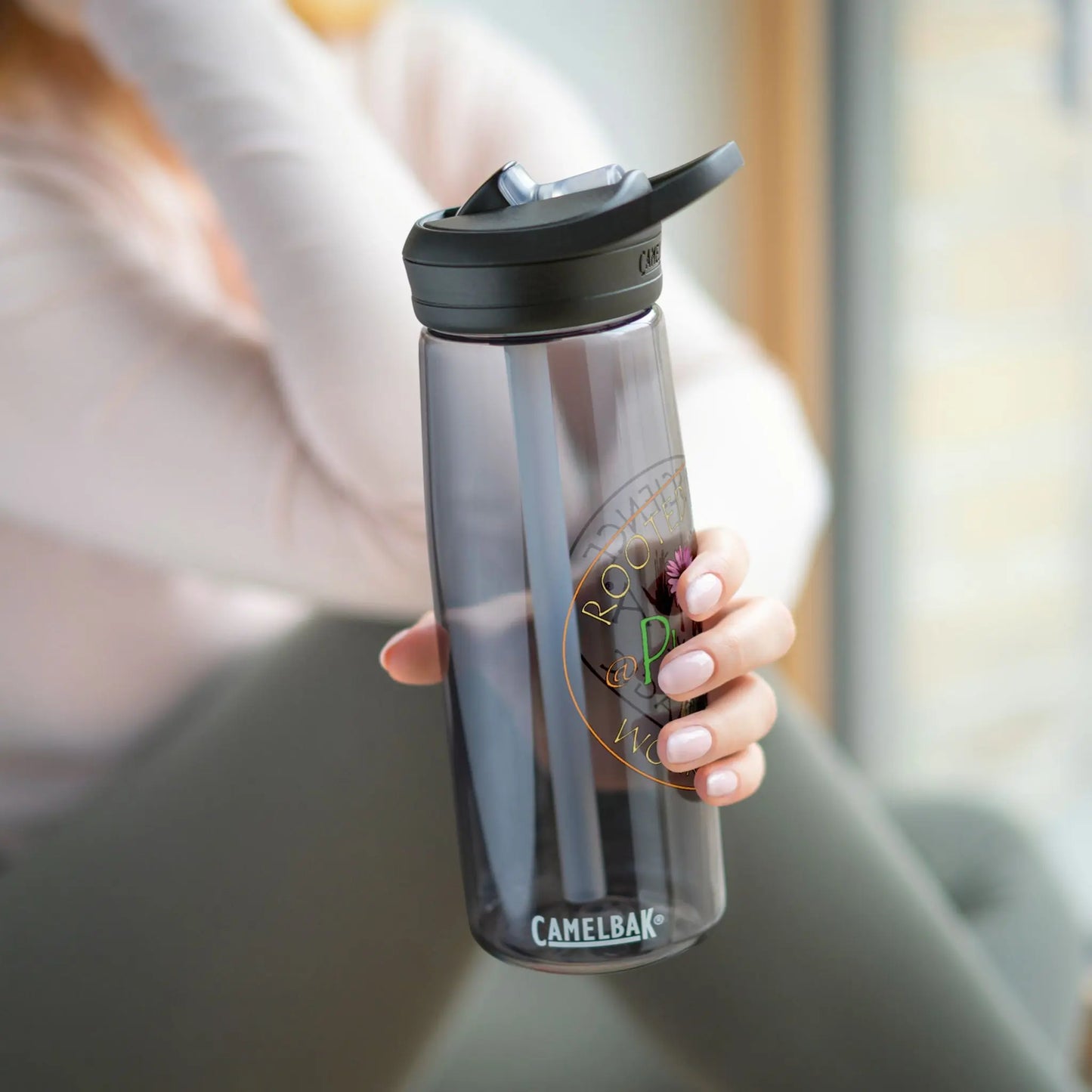 Woman holding a Plantiva Camelbak water bottle