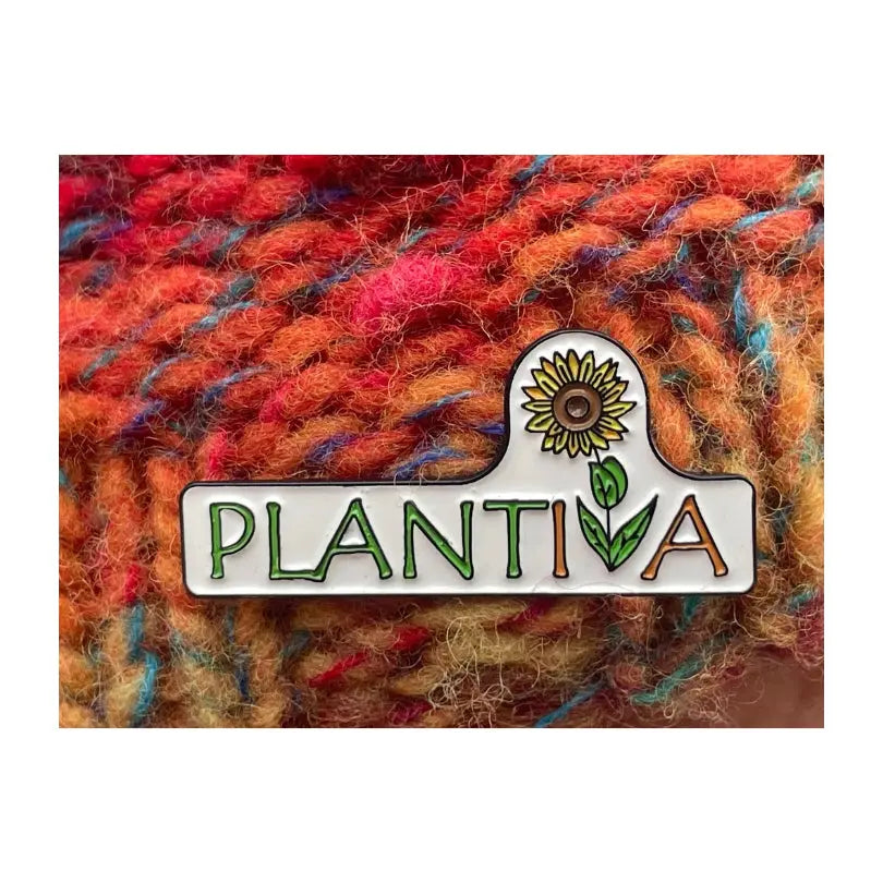 A hatpin with the Plantiva logo