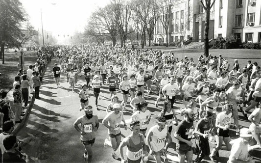 A historical black and white photo of runners