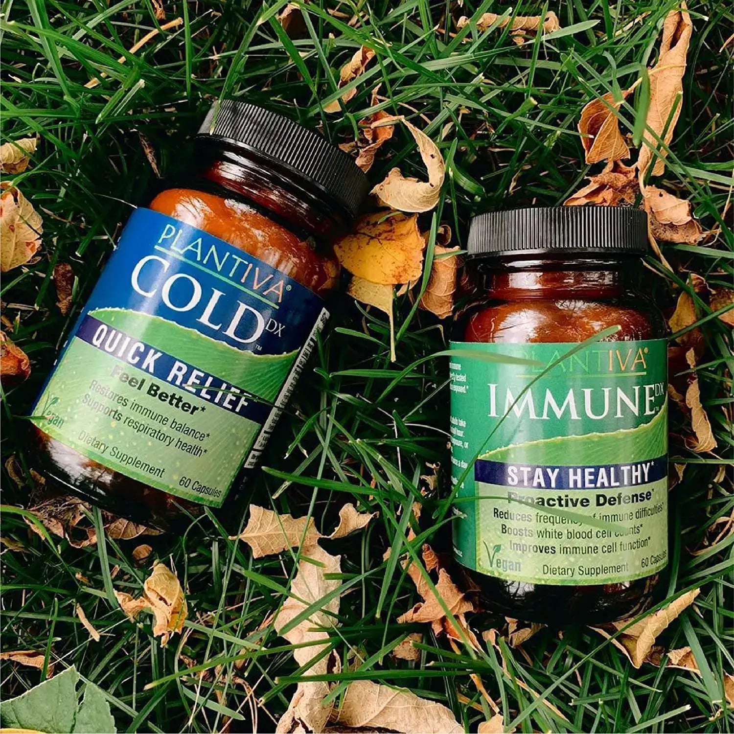 Bottles of ColdDx and ImmuneDx in the grass with fall leaves