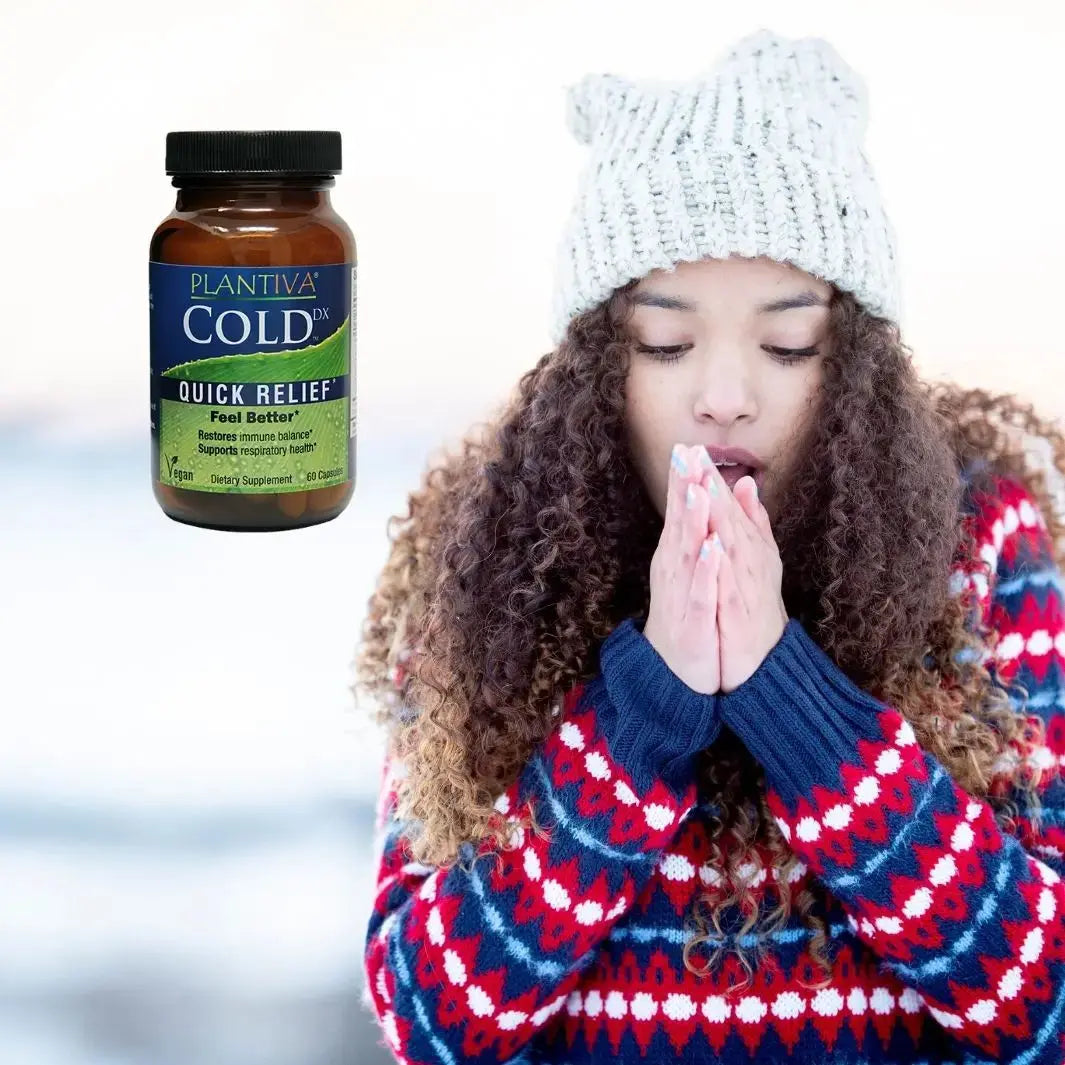 Woman wearing a winter hat and sweater with Plantiva Cold Dx on a snowy background