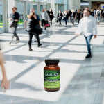 Bottle of ImmuneDx with people walking in a busy mall.