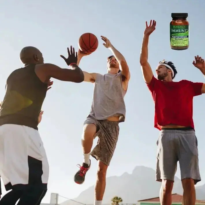 Three men playing basketball with a bottle of ImmuneDx in the corner.