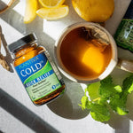 Plantiva Cold Dx Quick Relief supplement bottle with a cup of tea, lemon, and mint leaves on a counter.