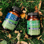 Bottles of Plantiva ImmuneDx and ColdDx supplements on grass with leaves