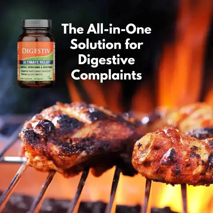 Grilled meat on a barbecue with a bottle of Digestiv in the corner.