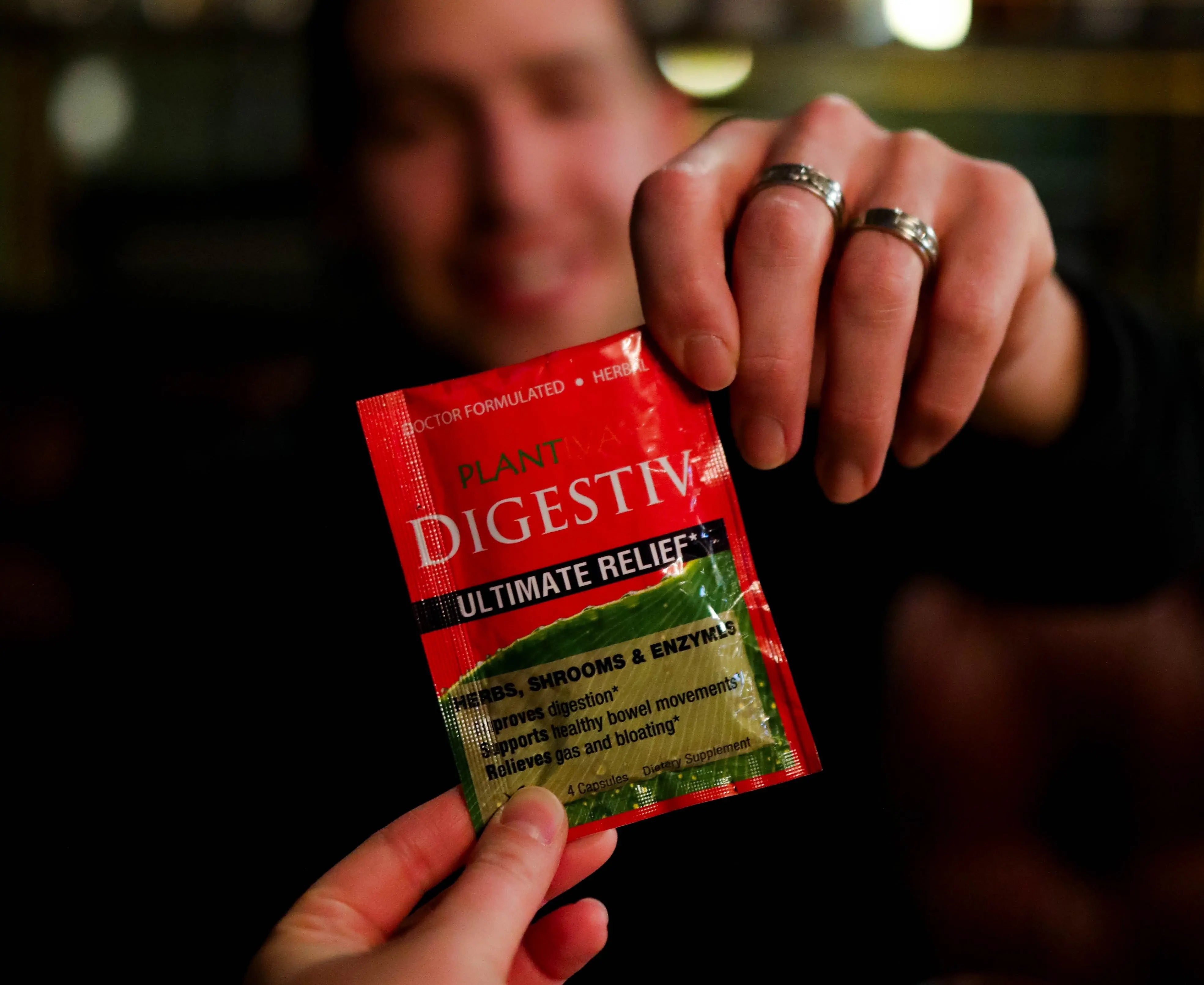 Person holding a packet of Digestiv in a restaurant