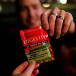 Person holding a packet of Digestiv in a restaurant