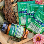 One bottle and 3 packets of ImmuneDx with flowers and other botanicals